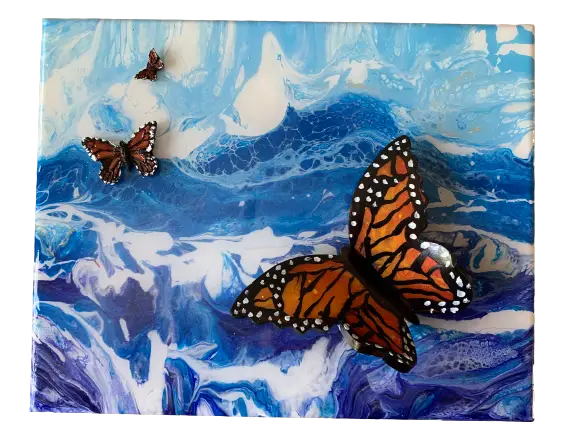 Butterflies flying across the ocean to Mexico. Blue waters are depicted with hand painted butterflies.