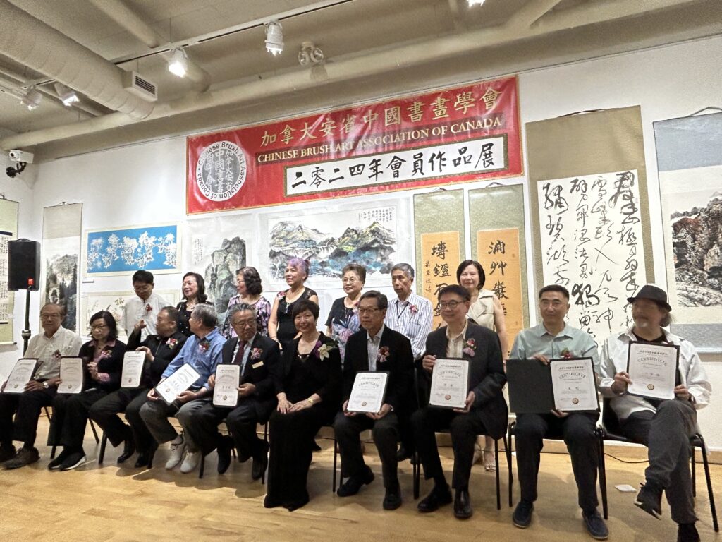 Two rows of people in front of the ceremony signage. the executive of the Chinese Trust Art Association.