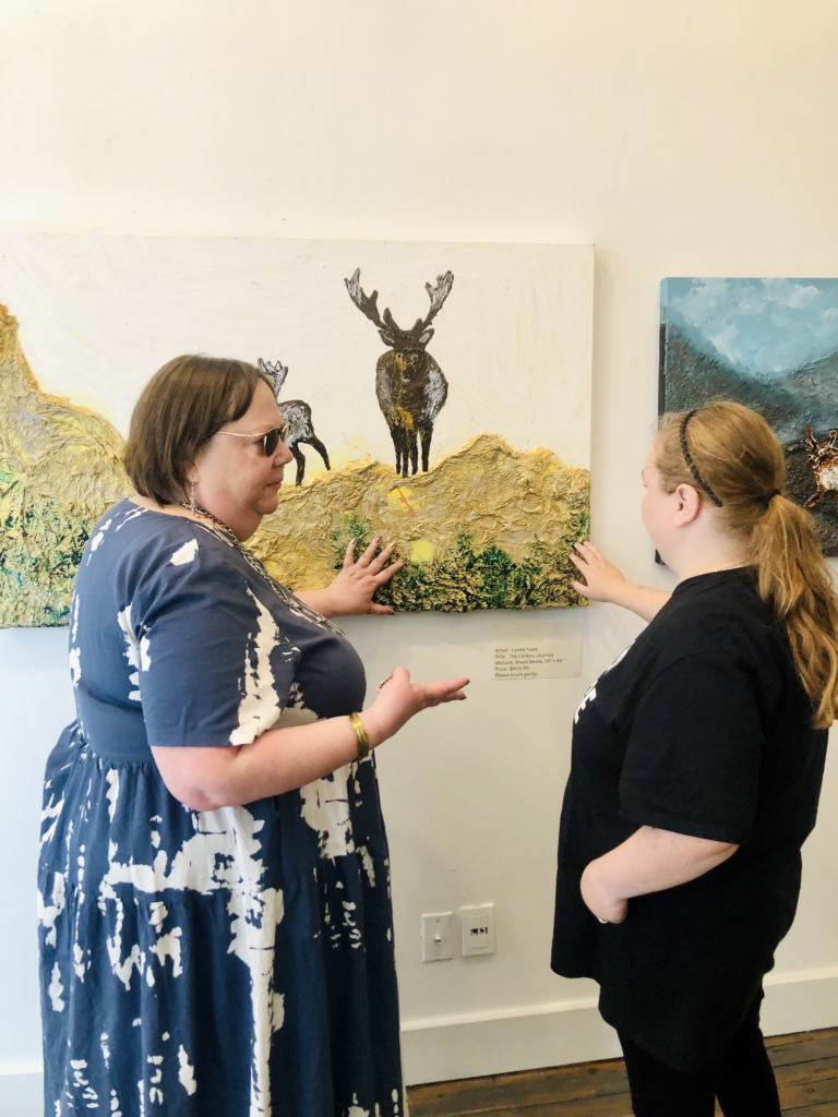 Myself and a visitor viewing the Caribou painting at the CNIB private exhibit.