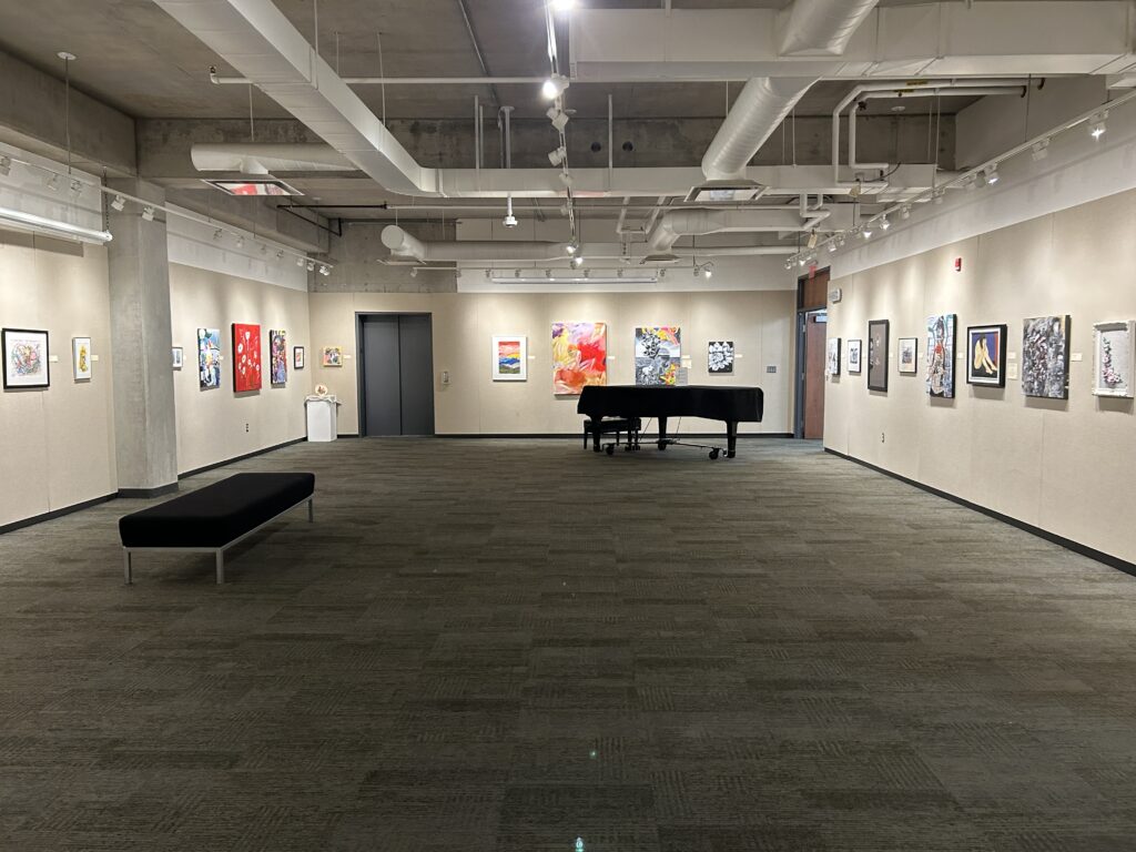 a picture of the John Parrot gallery. it shows a baby grand piano at the end of the room.