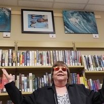 Lynda standing in front of one piece at the Warkworth library art exhibit through the Spirit of the Hills Art Association.